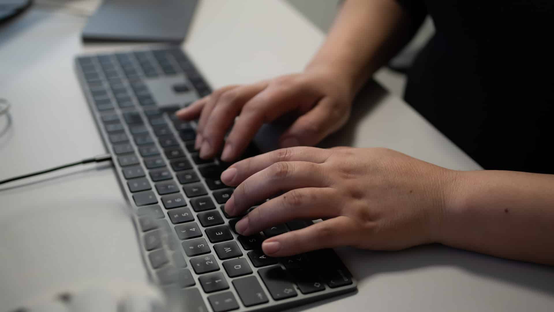Händer som skriver på ett tangentbord.